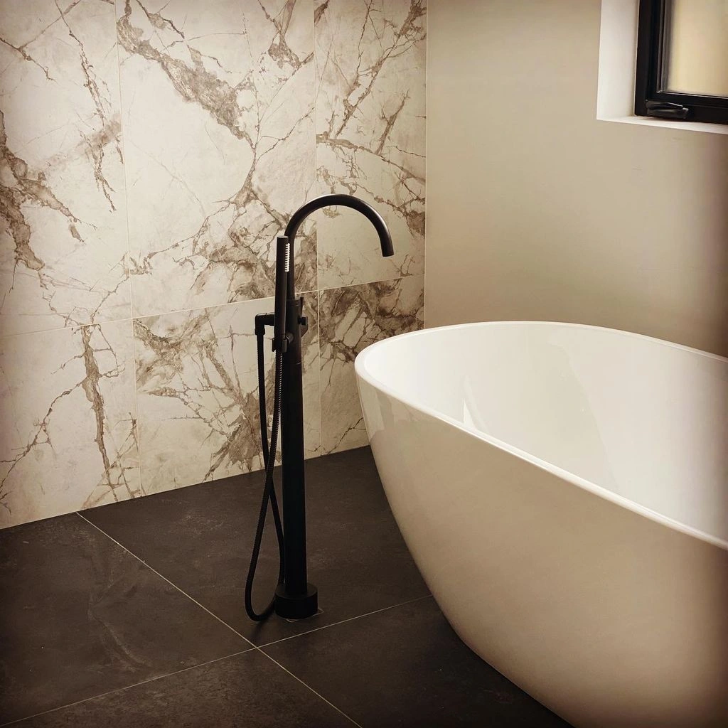 Freestanding bathtub installation in a luxury bathroom remodeling project in Mountain View, Silicon Valley, California